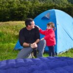 dad and son camping with tent