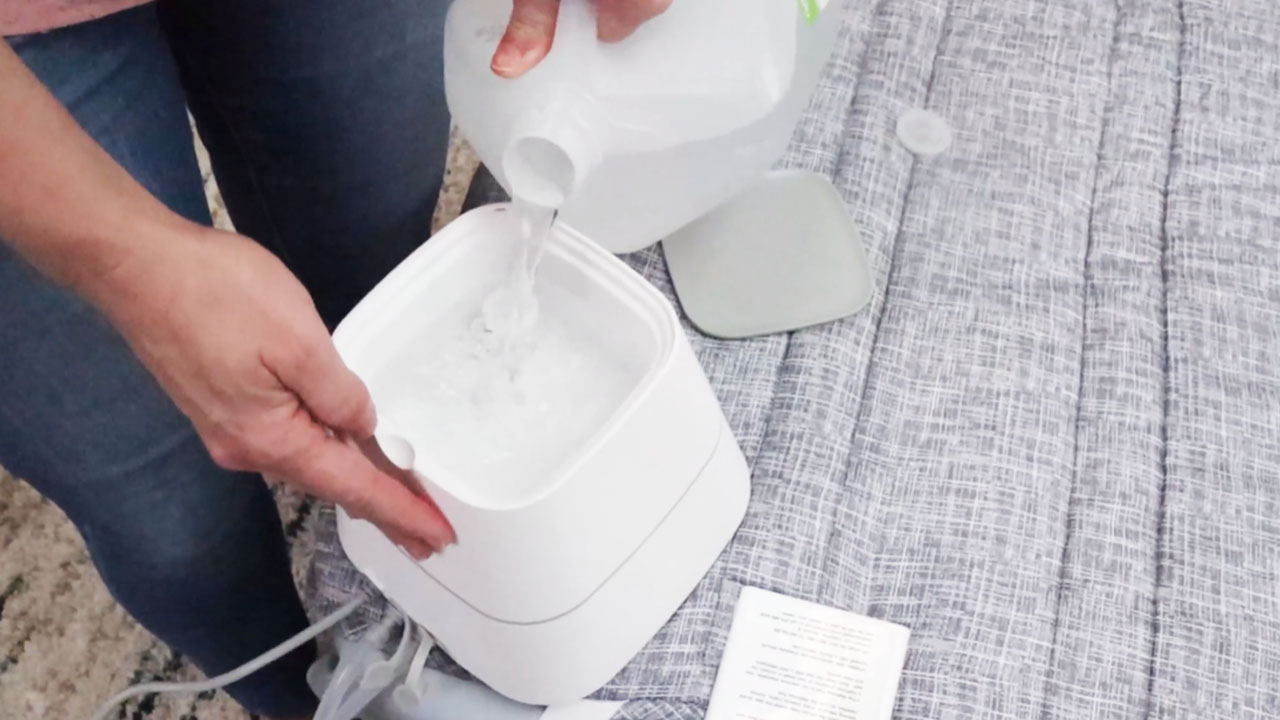 Pouring water into the Neat Water Heated Mattress Pad