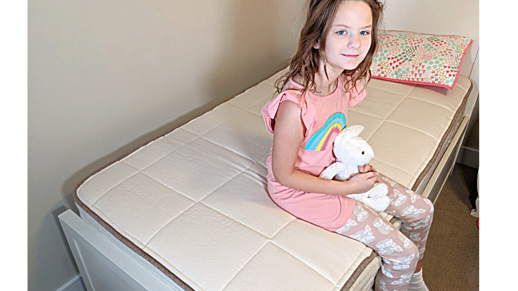 Child sitting on Nolah Nuture kid Mattress